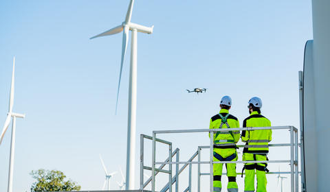 Drone flying near wind turbine