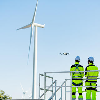 Drone flying near wind turbine